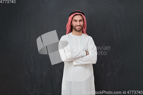 Image of Young muslim man with crossed arms smiling