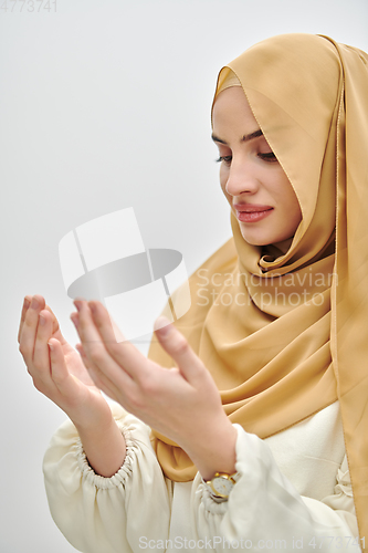 Image of Portrait of young muslim woman making dua, praying to God