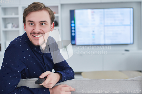 Image of Happy young muslim man in modern home