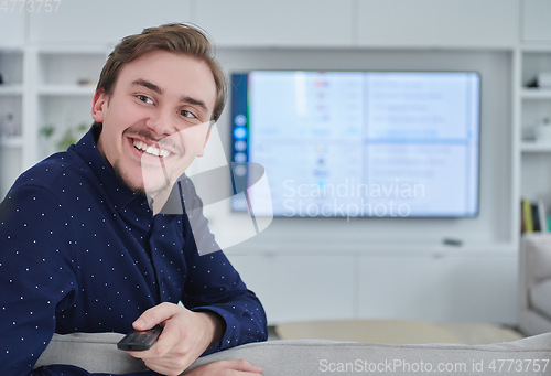 Image of Happy young muslim man in modern home