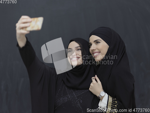 Image of Portrait of Arab women wearing traditional clothes or abaya taking selfie