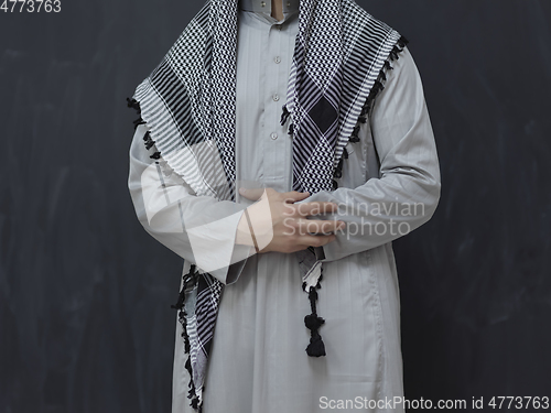 Image of Portrait of young muslim man wearing traditional clothes