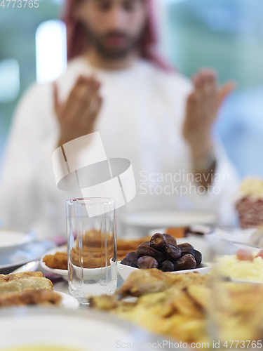 Image of Muslim man making iftar dua to break fasting during Ramadan