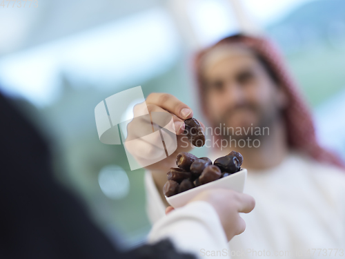 Image of Muslim couple sharing dates for starting iftar