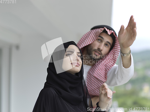 Image of Portrait of young muslim couple on balcony