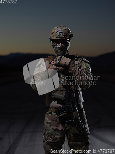 Image of soldier with full combat gear in night mission