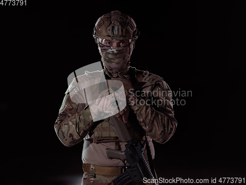 Image of soldier with full combat gear in night mission