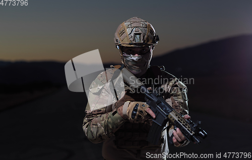 Image of soldier with full combat gear in night mission