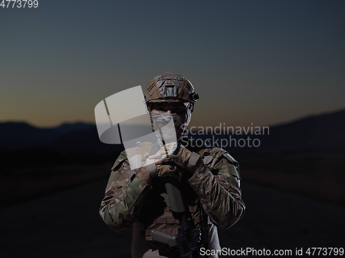 Image of soldier with full combat gear in night mission