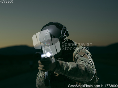 Image of soldier with full combat gear in night mission