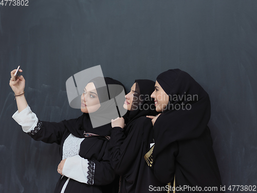 Image of Portrait of Arab women wearing traditional clothes or abaya taking selfie