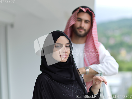 Image of Portrait of young muslim couple on balcony