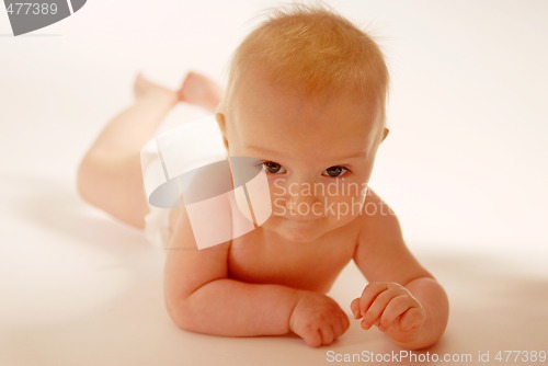 Image of Baby lying on a ground