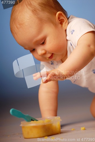 Image of Baby playing with a food