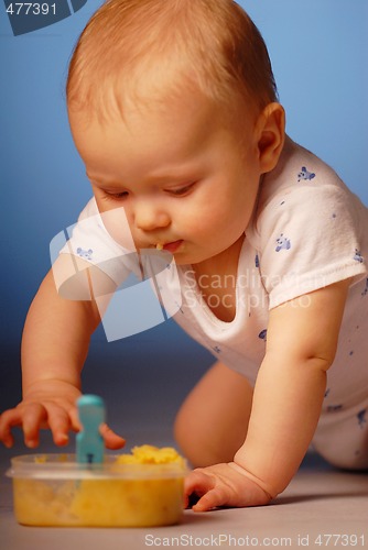 Image of Baby playing with a food
