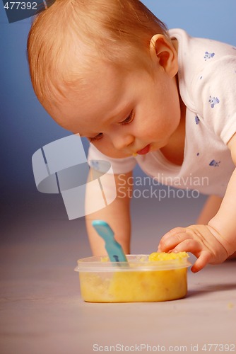 Image of Baby playing with a food