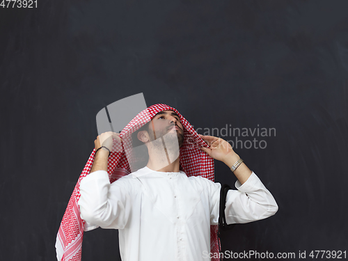 Image of Portrait of young muslim man wearing traditional clothes