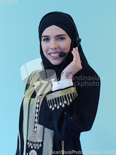 Image of Portrait of young muslim woman with headphones