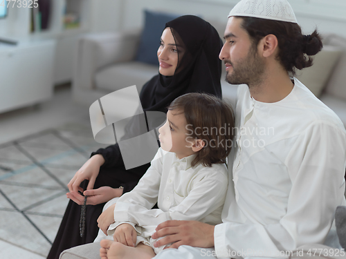 Image of Top view of young arabian muslim family wearing traditional clothes