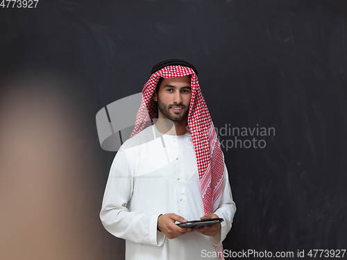 Image of Portrait of young muslim businessman using tablet