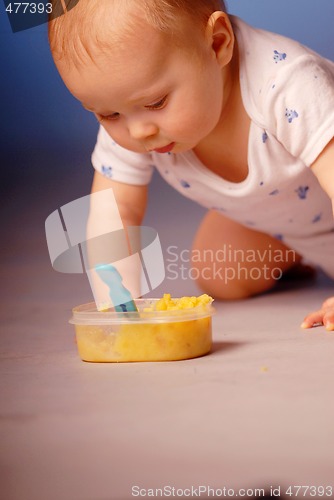 Image of Baby playing with a food