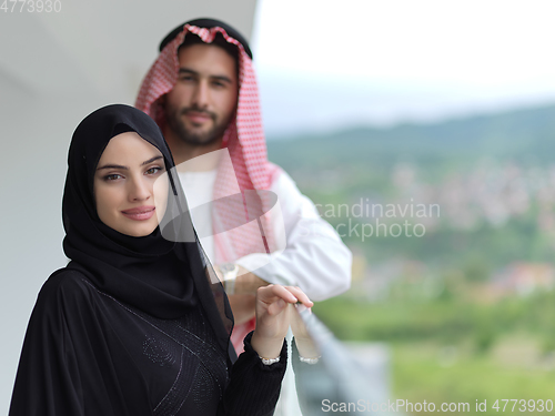 Image of Portrait of young muslim couple on balcony