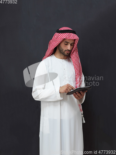 Image of Portrait of young muslim businessman using tablet