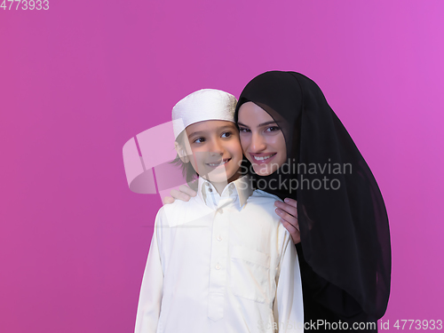 Image of young arabian mother and son wearing traditional clothes