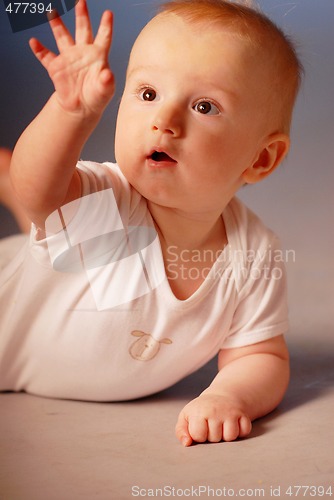 Image of Little boy examining his hand