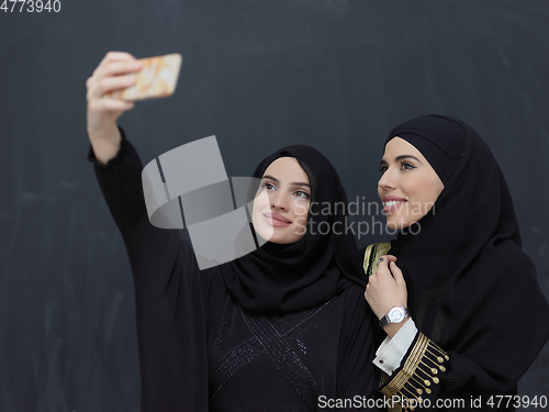 Image of Portrait of Arab women wearing traditional clothes or abaya taking selfie