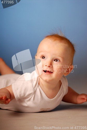 Image of A smiling little boy on a floor