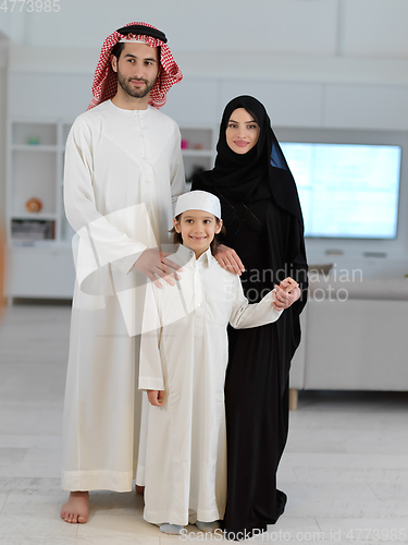 Image of young arabian muslim family wearing traditional clothes