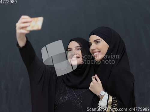 Image of Portrait of Arab women wearing traditional clothes or abaya taking selfie