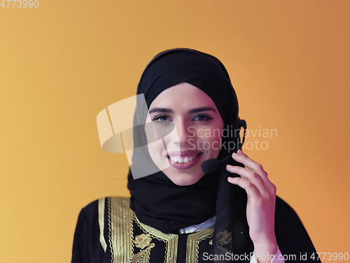 Image of Portrait of young muslim woman with headphones