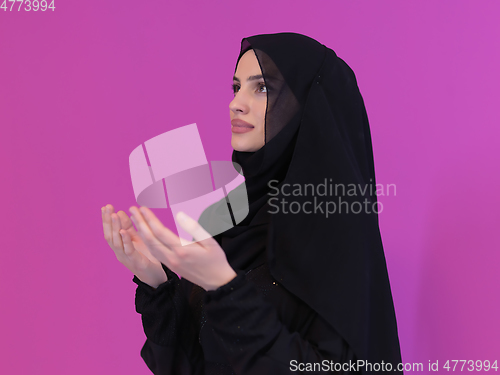 Image of Portrait of young Muslim woman making dua