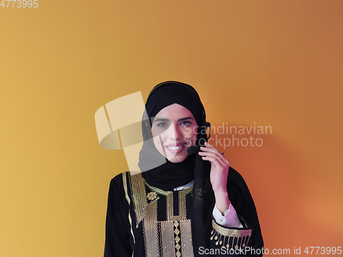 Image of Portrait of young muslim woman with headphones