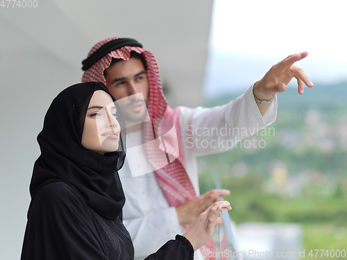 Image of Portrait of young muslim couple on balcony