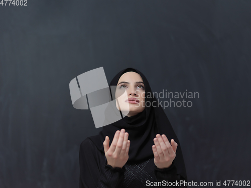 Image of Portrait of young Muslim woman making dua