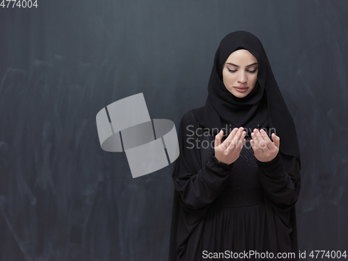 Image of Portrait of young Muslim woman making dua