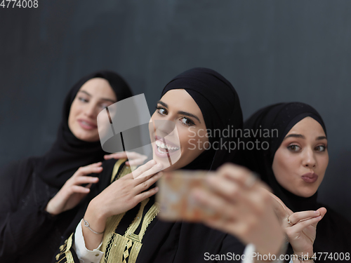 Image of Portrait of Arab women wearing traditional clothes or abaya taking selfie