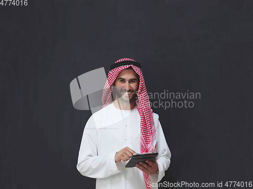 Image of Portrait of young muslim businessman using tablet