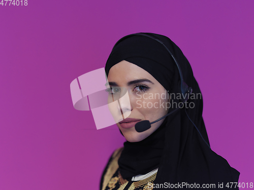 Image of Portrait of young muslim woman with headphones