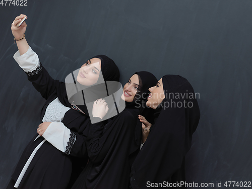 Image of Portrait of Arab women wearing traditional clothes or abaya taking selfie