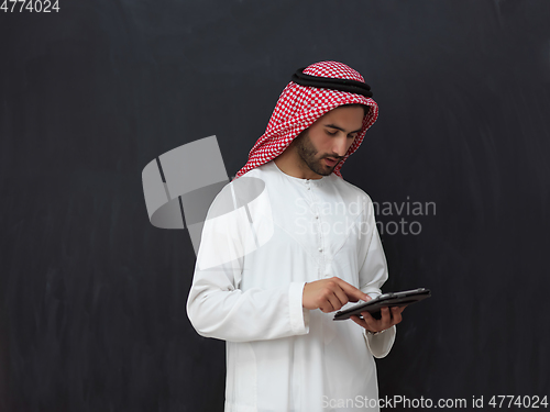 Image of Portrait of young muslim businessman using tablet
