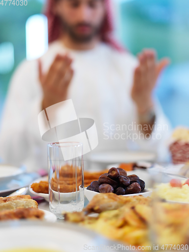 Image of Muslim man making iftar dua to break fasting during Ramadan