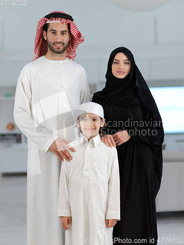 Image of young arabian muslim family wearing traditional clothes