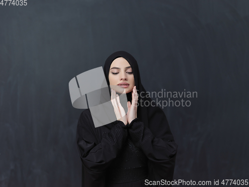 Image of Portrait of young Muslim woman making dua
