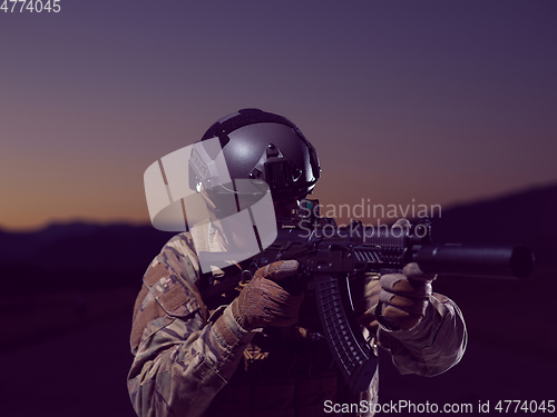 Image of soldier with full combat gear in night mission