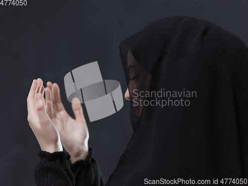 Image of Portrait of young Muslim woman making dua