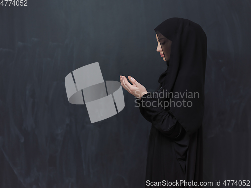 Image of Portrait of young Muslim woman making dua